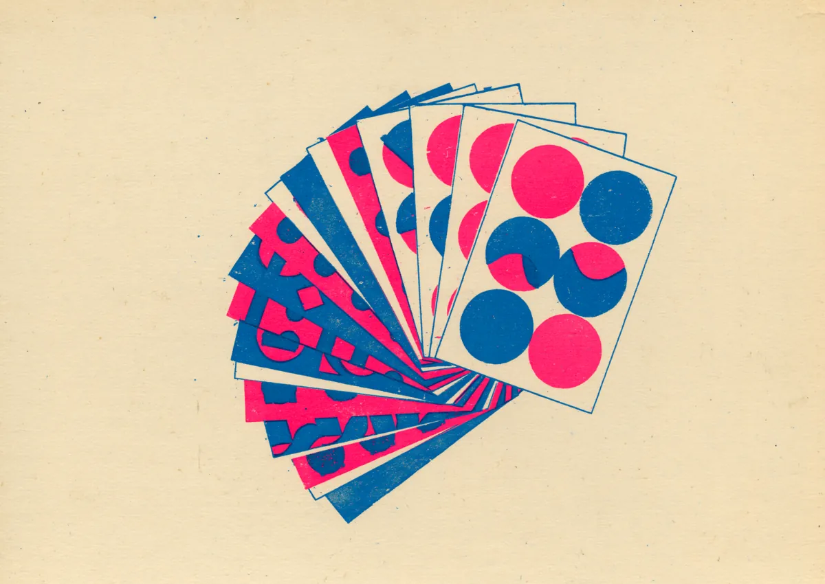 A fanned deck of color swatch cards in pink, blue and cream with dot motifs