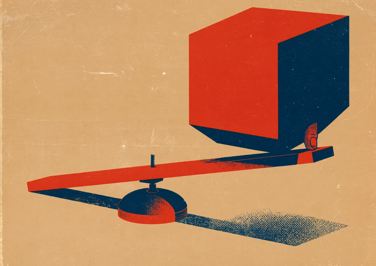 A red cube balanced on a seesaw over a long shadow
