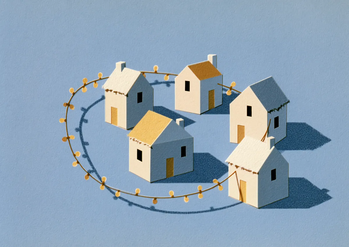 A row of small houses strung along a looping wire path