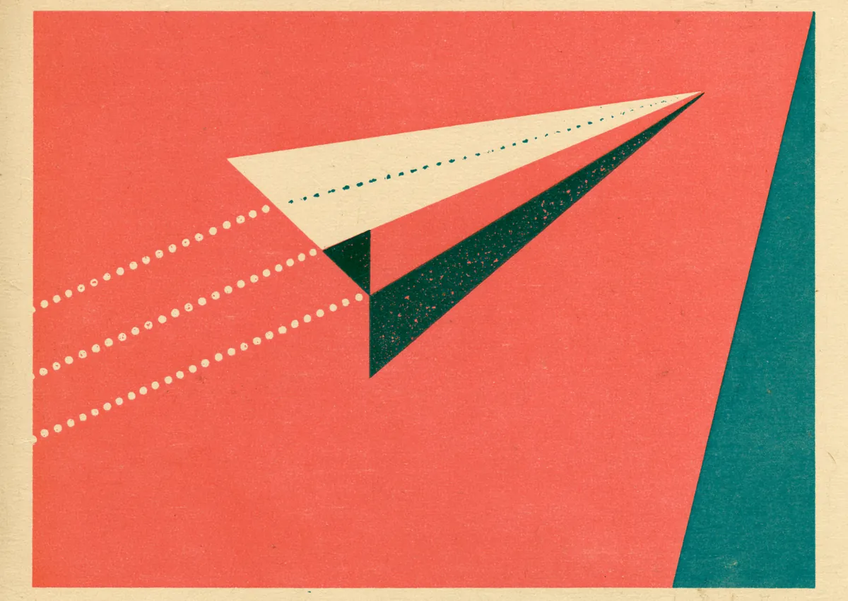A red paper airplane in flight leaving a trail of lines