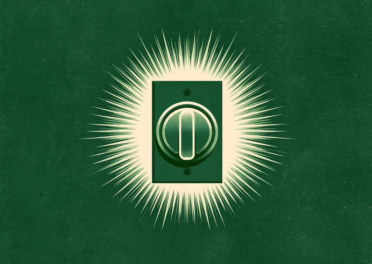 A glowing green power button radiating light on a dark ground