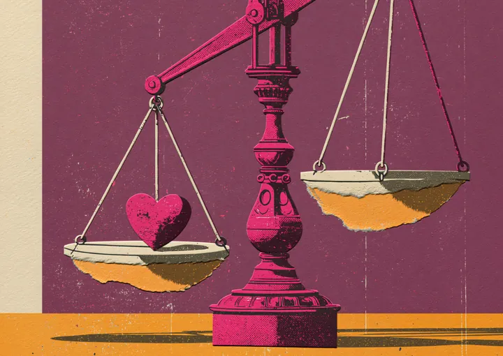 A pink set of balance scales weighing two dishes against each other