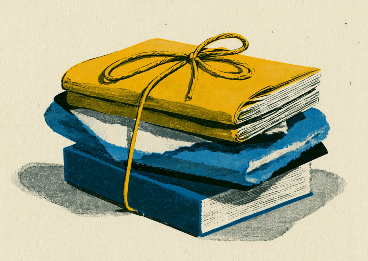 A neat stack of gold and blue folders tied with string