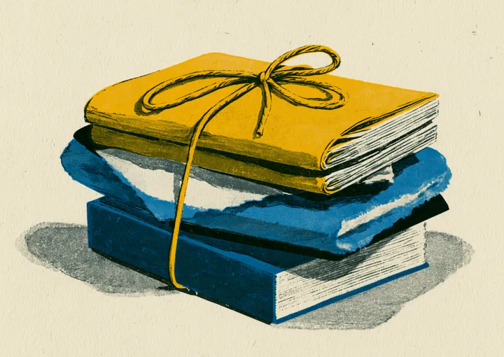 A neat stack of gold and blue folders tied with string