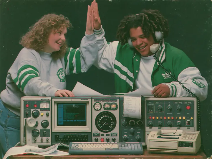 Teammates high-fiving over vintage electronics