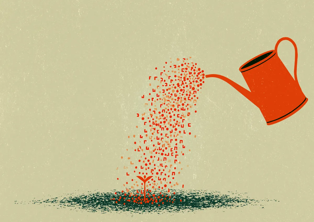 A watering can pouring a stream of dots onto the ground